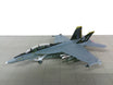 Plastic 1:100 scale McDonnell Douglas F/A-18F US Navy display model with a stand.