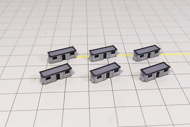 Set of six black and grey plastic 1:400 scale portable cabins for airport dioramas.
