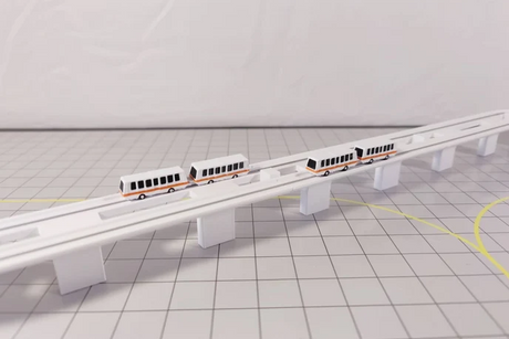 Custom 3D printed plastic automated people mover sky train model in 1:400 scale.